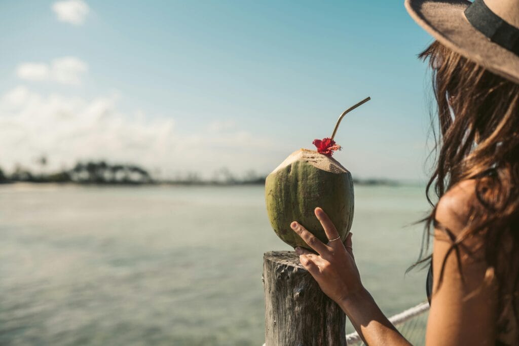 Person Holding a Coconut Drink