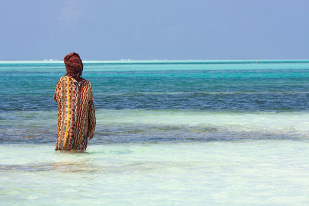 Woman in Turban and Traditional Clothing Standing in Sea