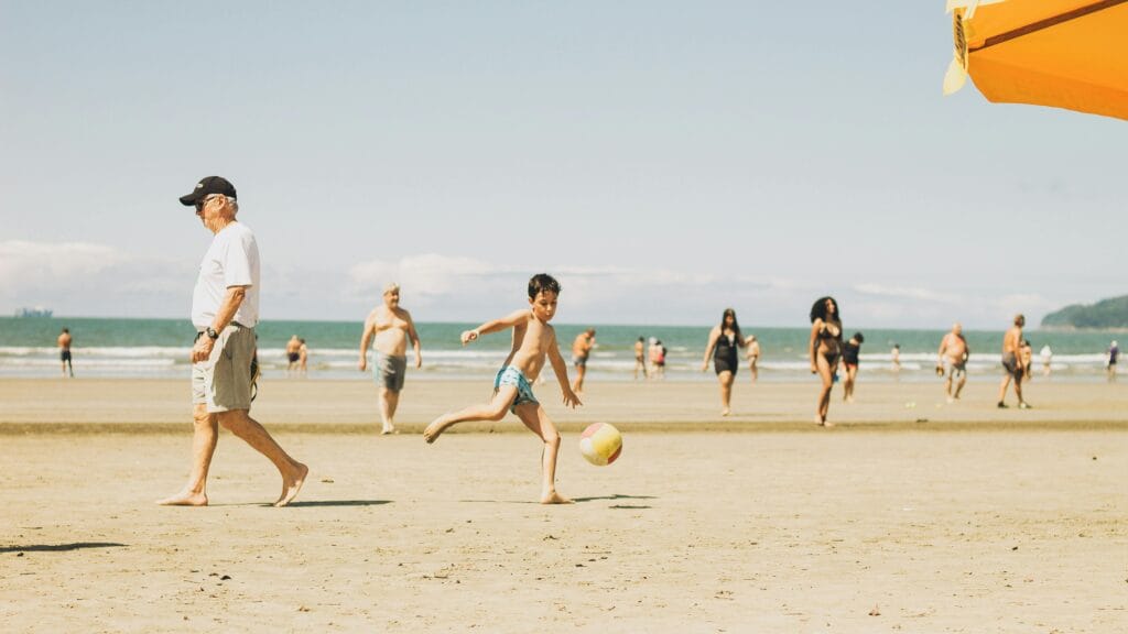 A lively beach scene in Brazil with people enjoying a sunny day by the ocean.