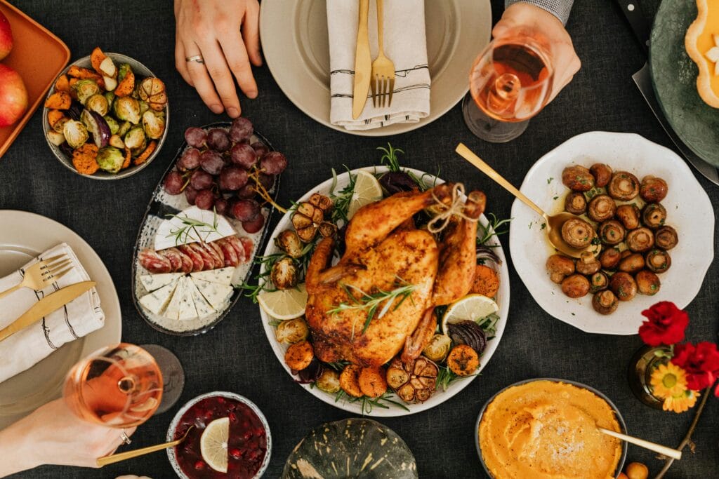 Top-down view of a delicious roast chicken dinner surrounded by sides on a festive table.