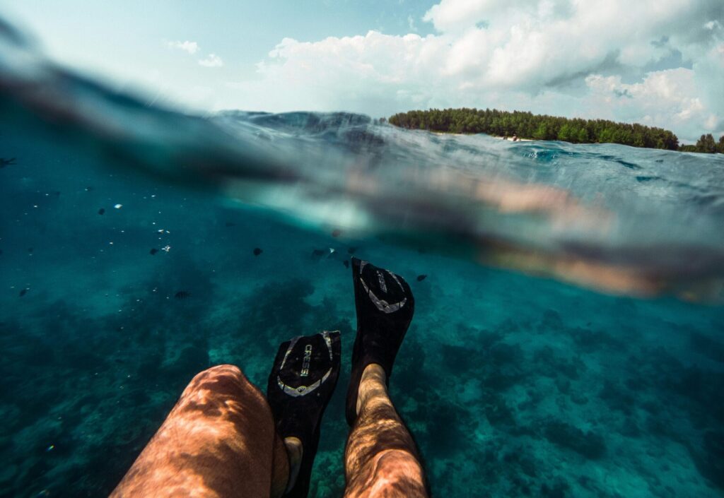 Serene ocean view from underwater with flippers in Nungwi, Tanzania.
