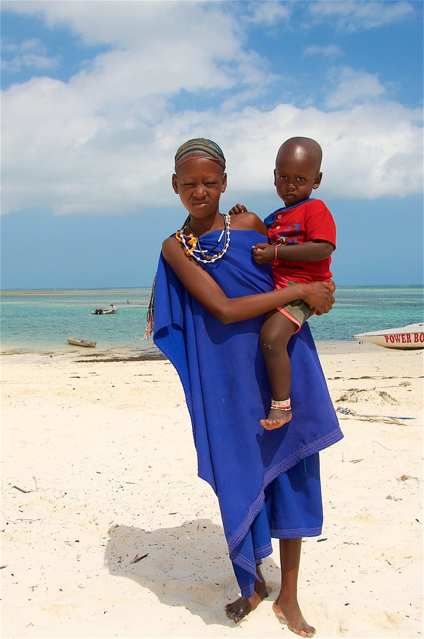 Unforgettable Tanzania Safari and Zanzibar – The Perfect 5-Day Escape 1 woman with a child, beach, zanzibar