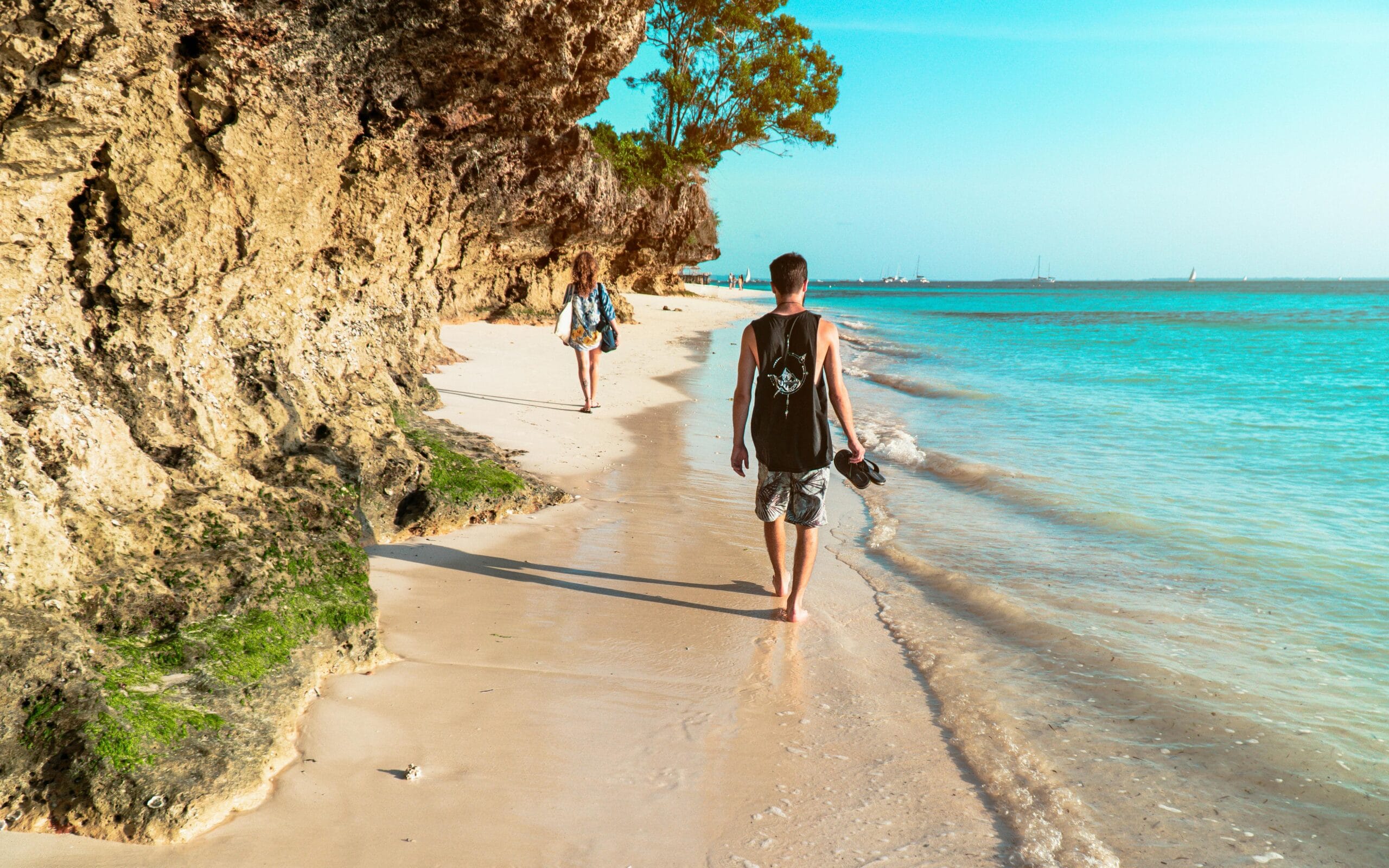 Exploring the serene beach of Nungwi, Tanzania with clear turquoise waters and sandy shores.