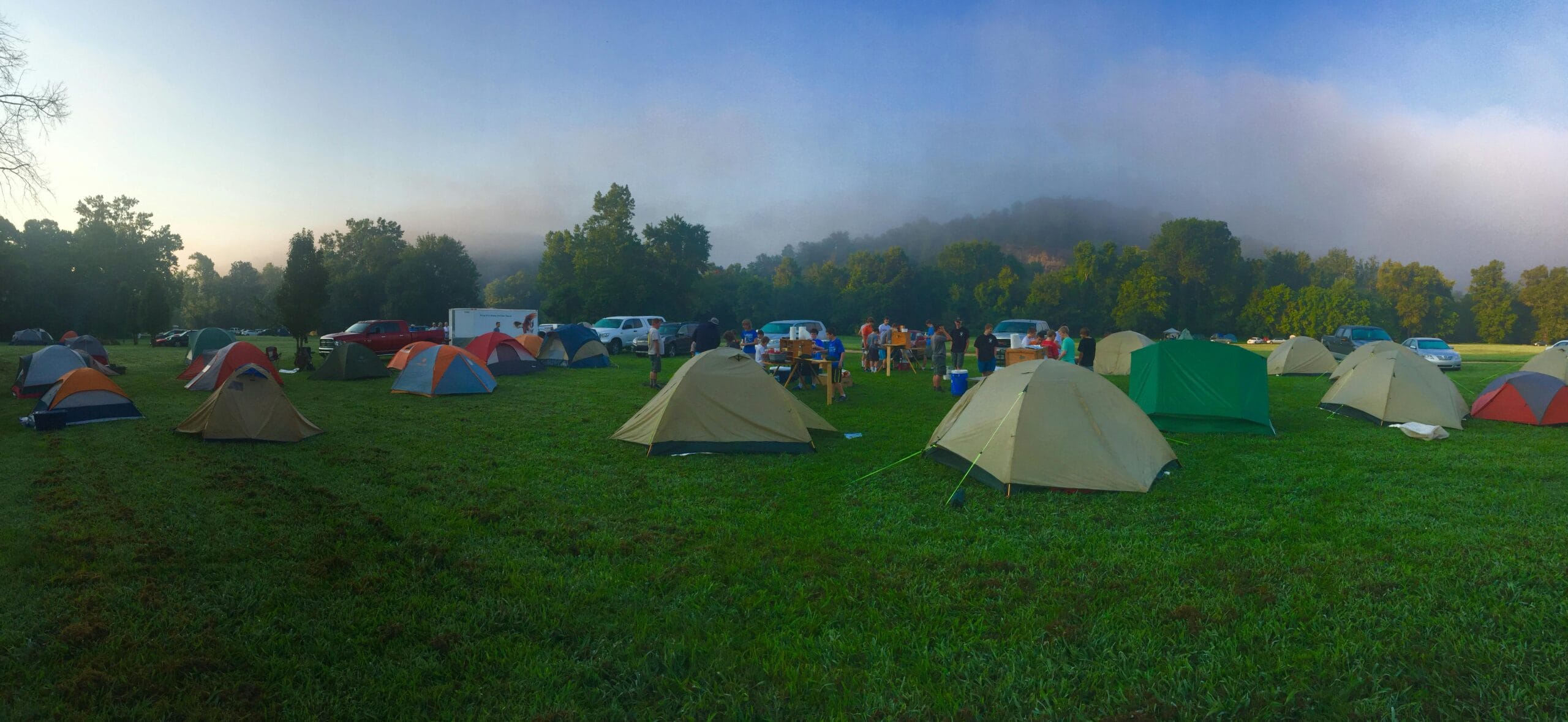 9-Day Budget Camping Safari for Adventurers 1 Lively camping site with multiple tents and people enjoying the outdoors in Windyville, Missouri.