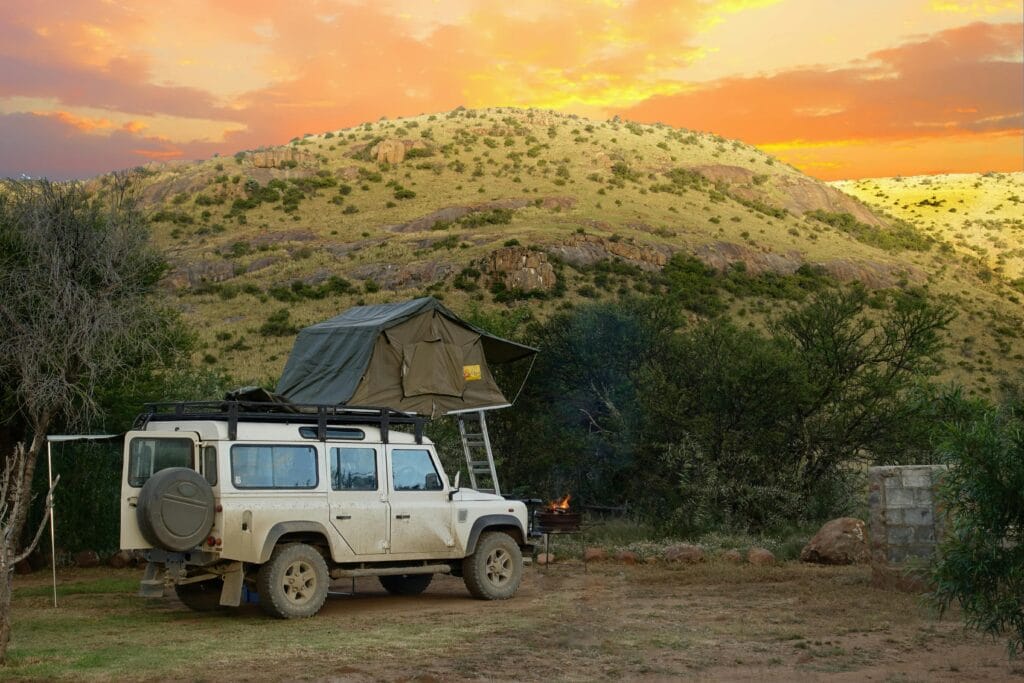 Northern Circuit 10-day safari guide 5 Land Rover with rooftop tent at sunset in the Bo-Karoo, South Africa, perfect for adventure travel.