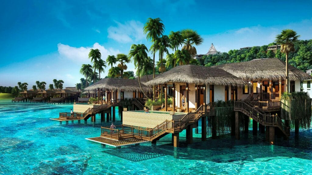 Luxury Lodge Experiences in Tanzania 4 Scenic view of tropical overwater villas surrounded by clear blue water and palm trees in Vietnam.