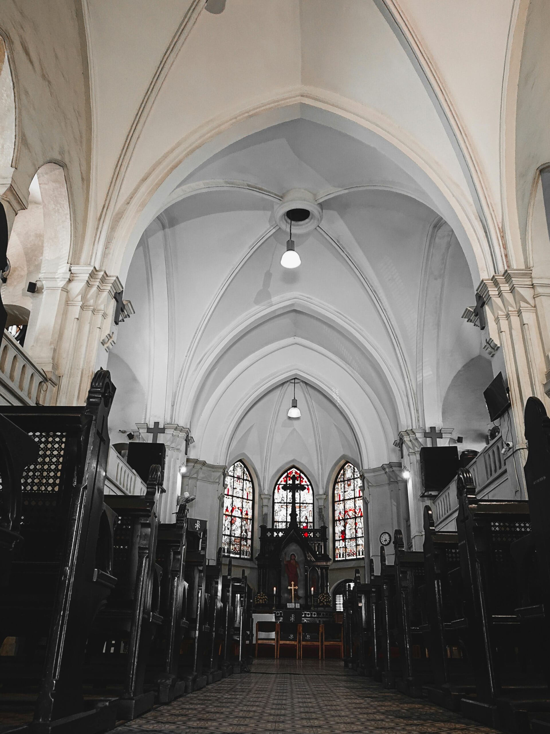 Respecting Sacred Sites on Safari: A Guide for Responsible Travelers in Tanzania 1 Majestic interior view of a historic church with stained glass windows in Dar es Salaam, Tanzania.
