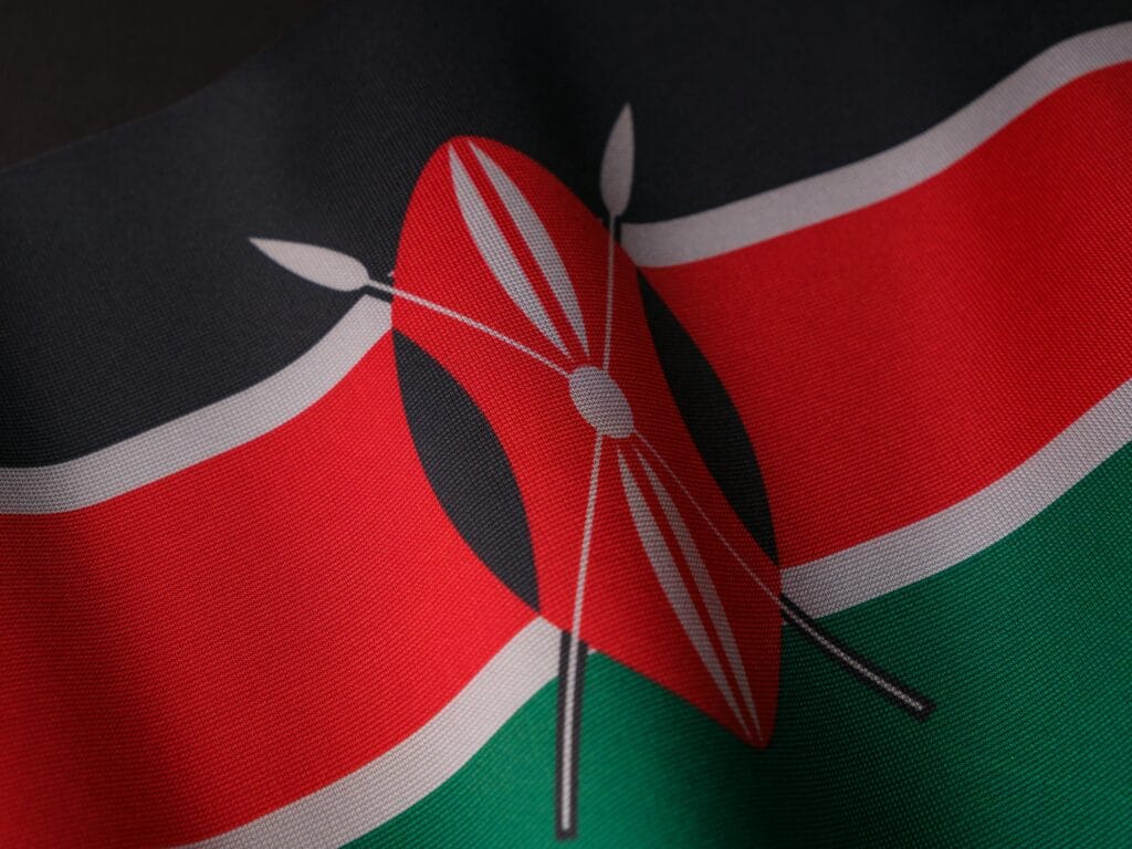 Combining Kenya and Tanzania in one trip 15 Detailed close-up of the vibrant Kenyan flag waving with texture visible.