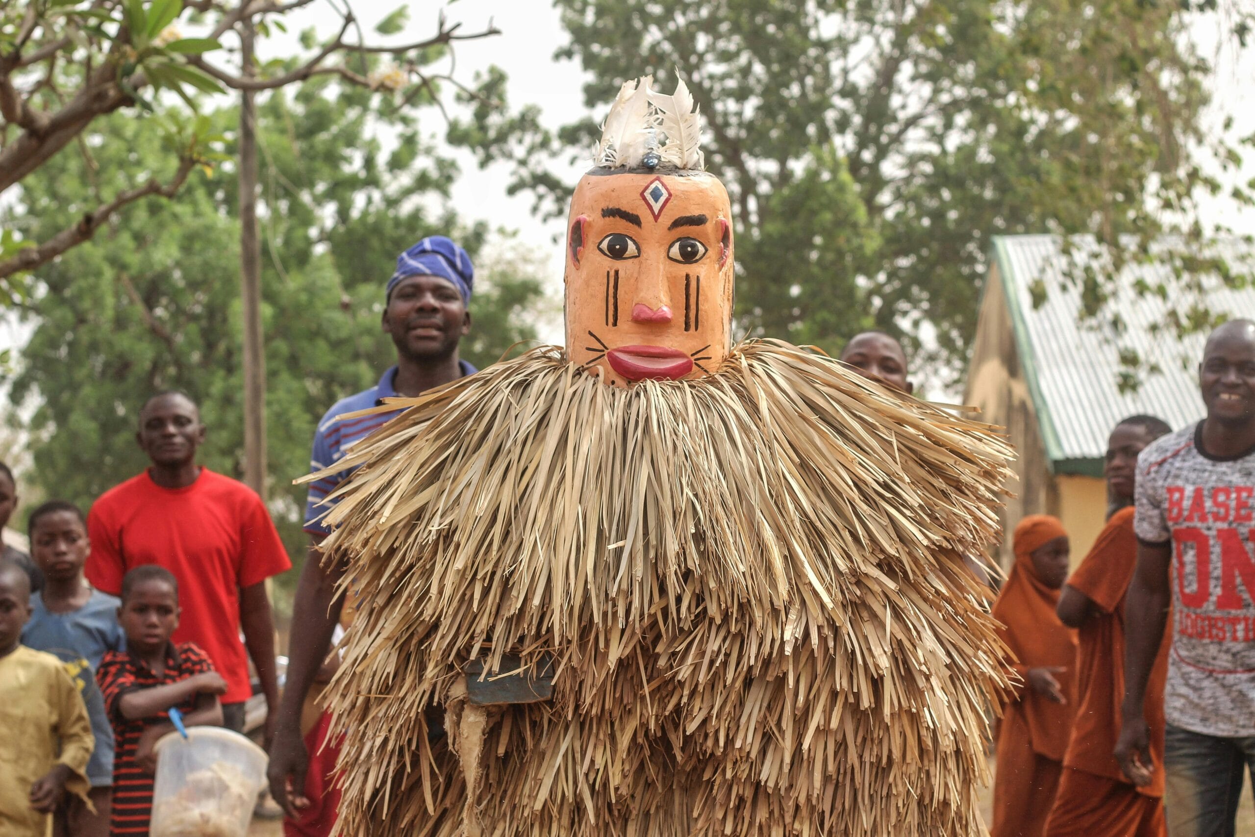 Vibrant African festival with traditional costumes and mask performance, capturing cultural essence.