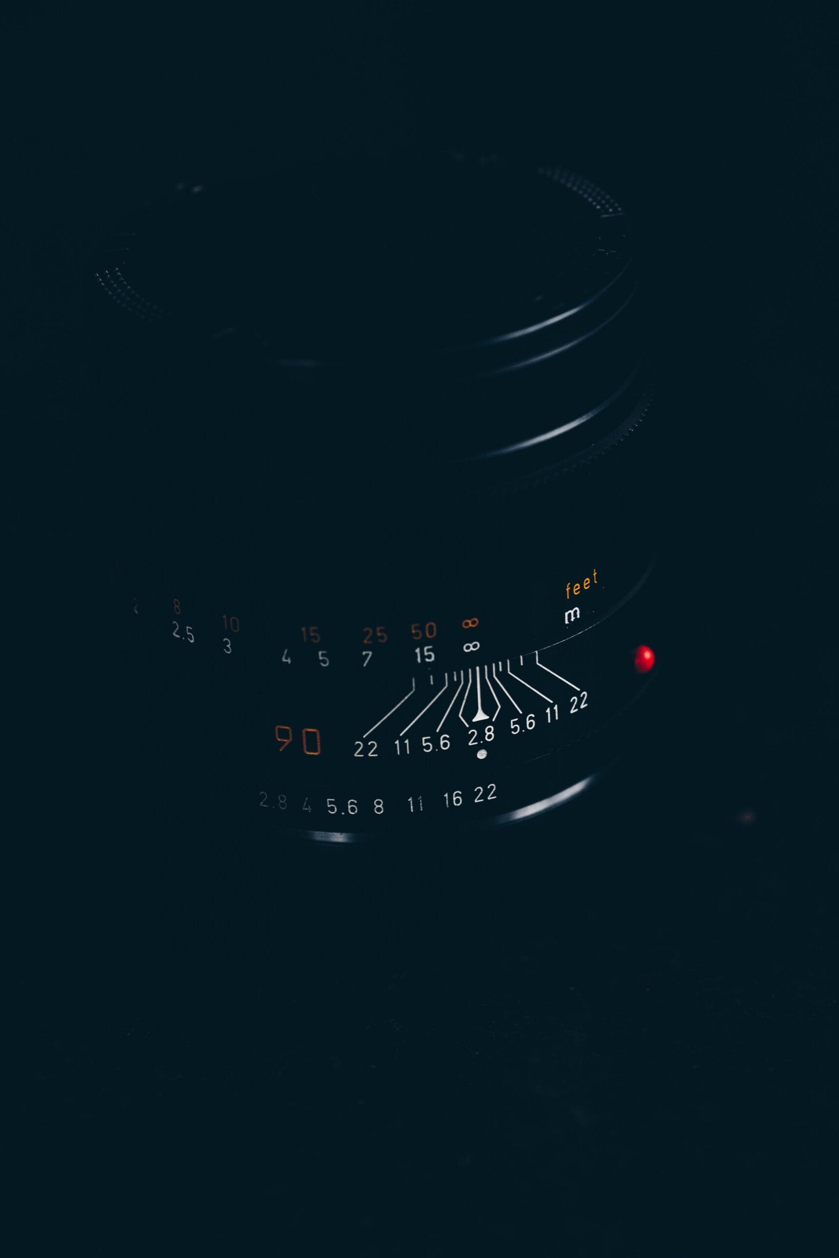 Best camera lenses for safari photos 1 A detailed view of a camera lens with focus markings highlighted against a dark background.
