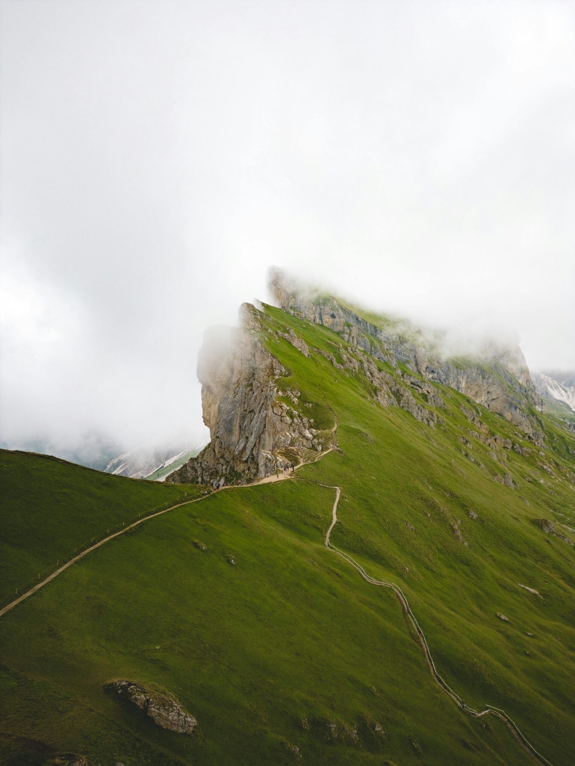 Wildlife Seasons in Ngorongoro: A Month-by-Month Guide 1 Mist-shrouded mountains and winding paths in the Dolomites, Italy, offer a serene landscape.