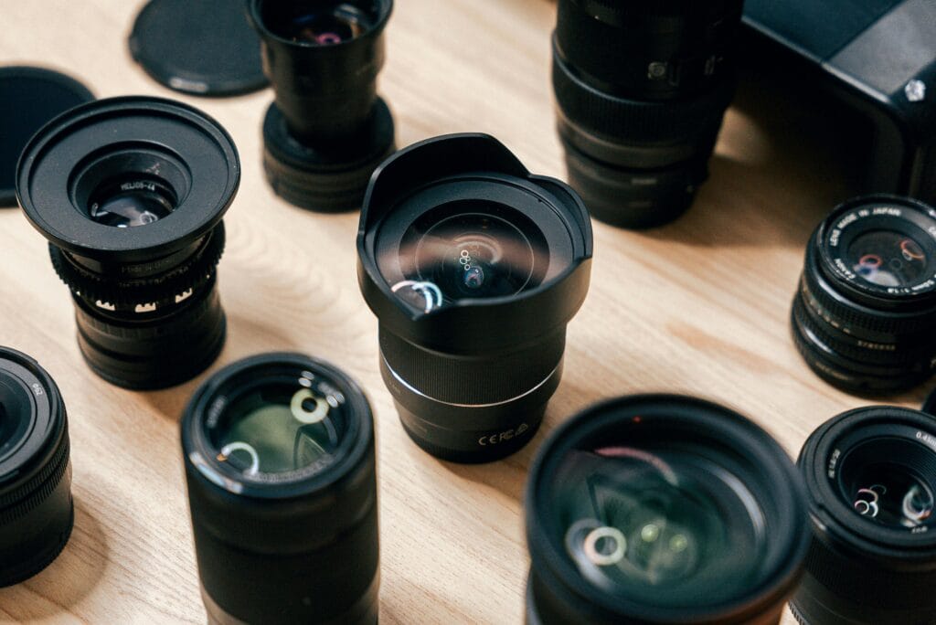 Close-up view of various camera lenses arranged on a table. Perfect for photography enthusiasts.