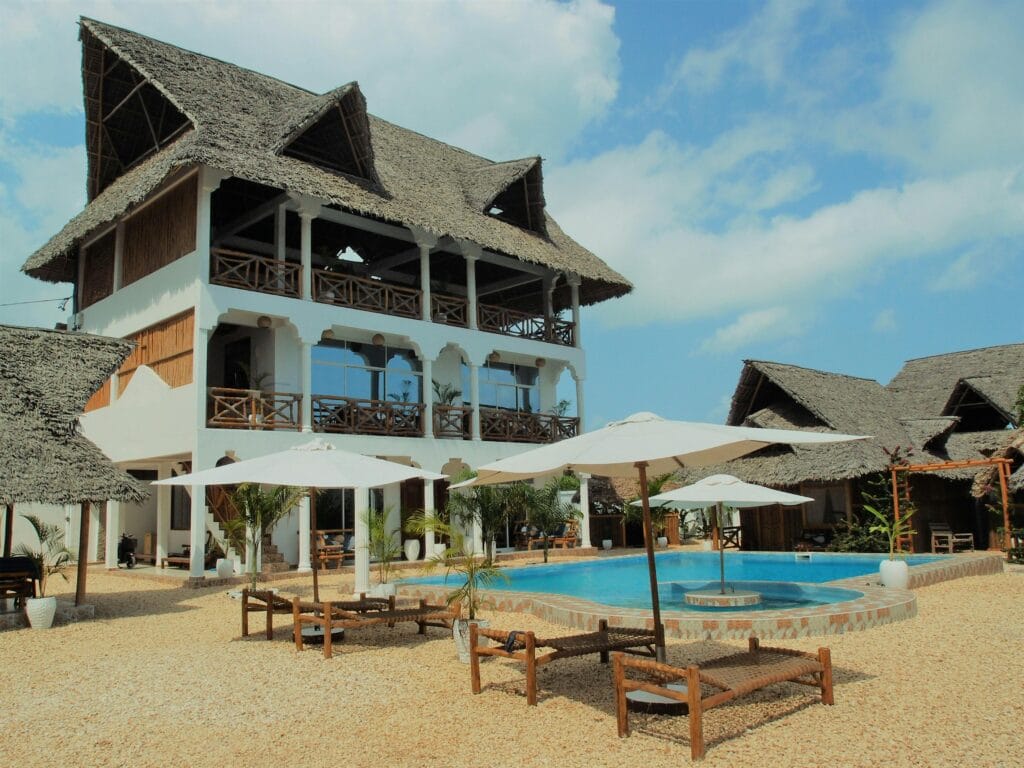 Explore this stunning Zanzibar resort with a pool, surrounded by villas and beautiful architecture.