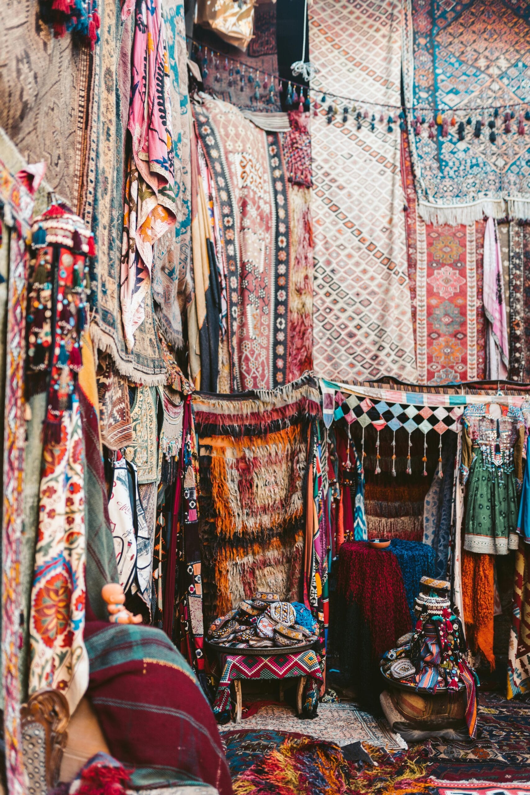 How Safari Tourism Supports Local Crafts: Preserving Culture and Empowering Communities 1 Vibrant display of traditional Turkish carpets and textiles in a lively outdoor bazaar.