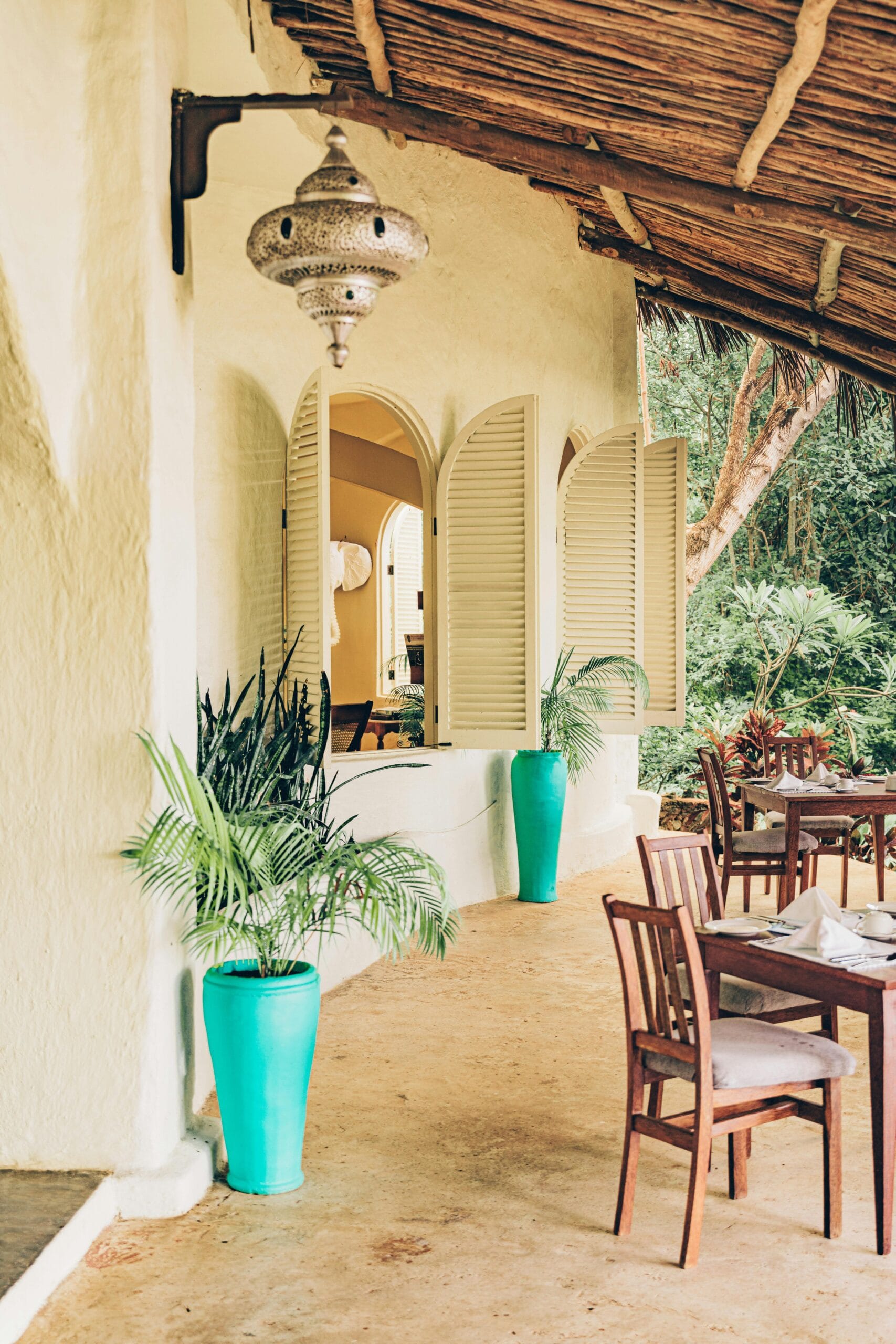 Top-rated hotels in Zanzibar for safaris 1 Elegant outdoor seating with tropical decor in Zanzibar, Tanzania.