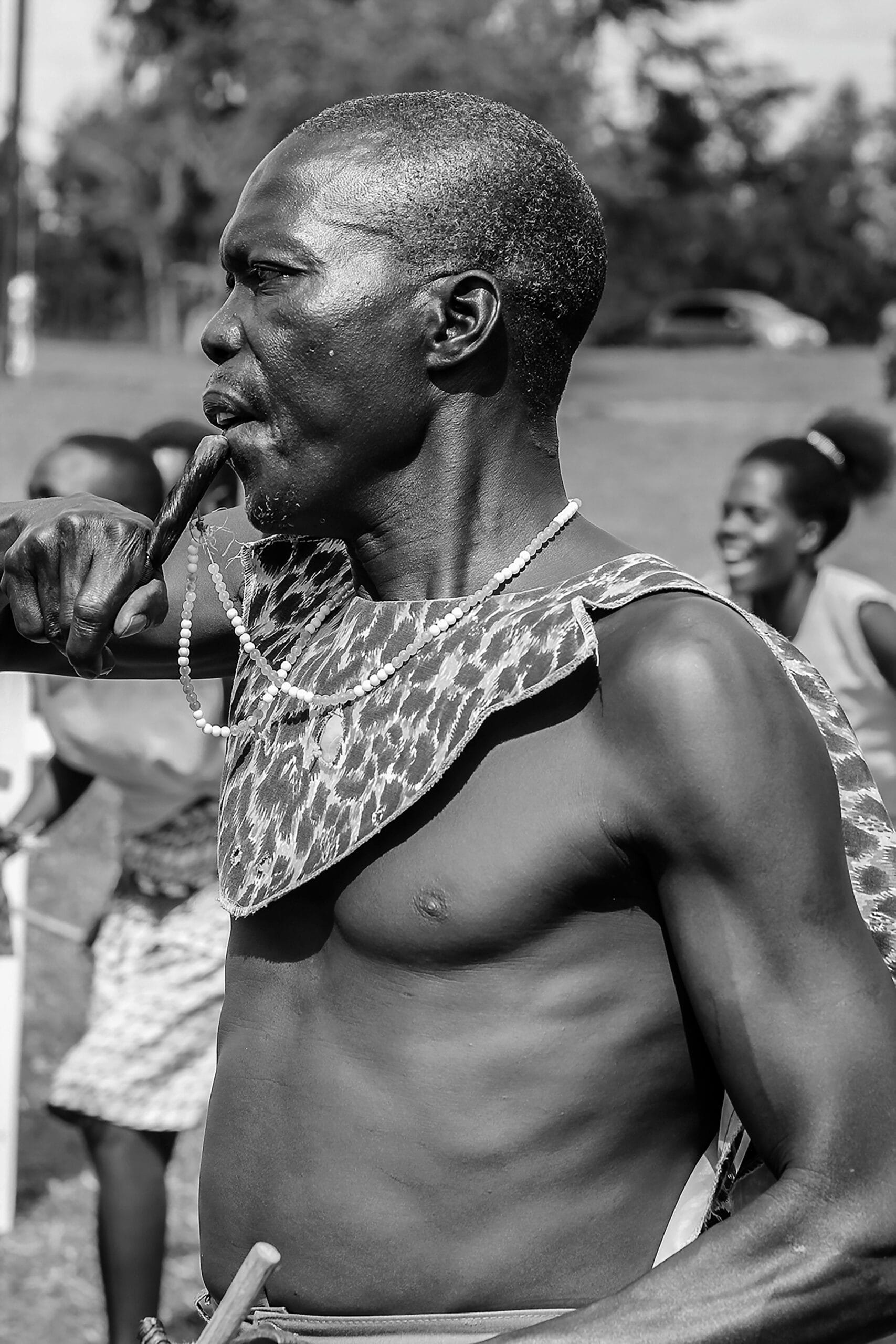 Cultural Festivals Near Safari Parks: Celebrate Africa’s Traditions While Immersed in the Wild 1 Black and white side view of old African American man in traditional clothes during local party