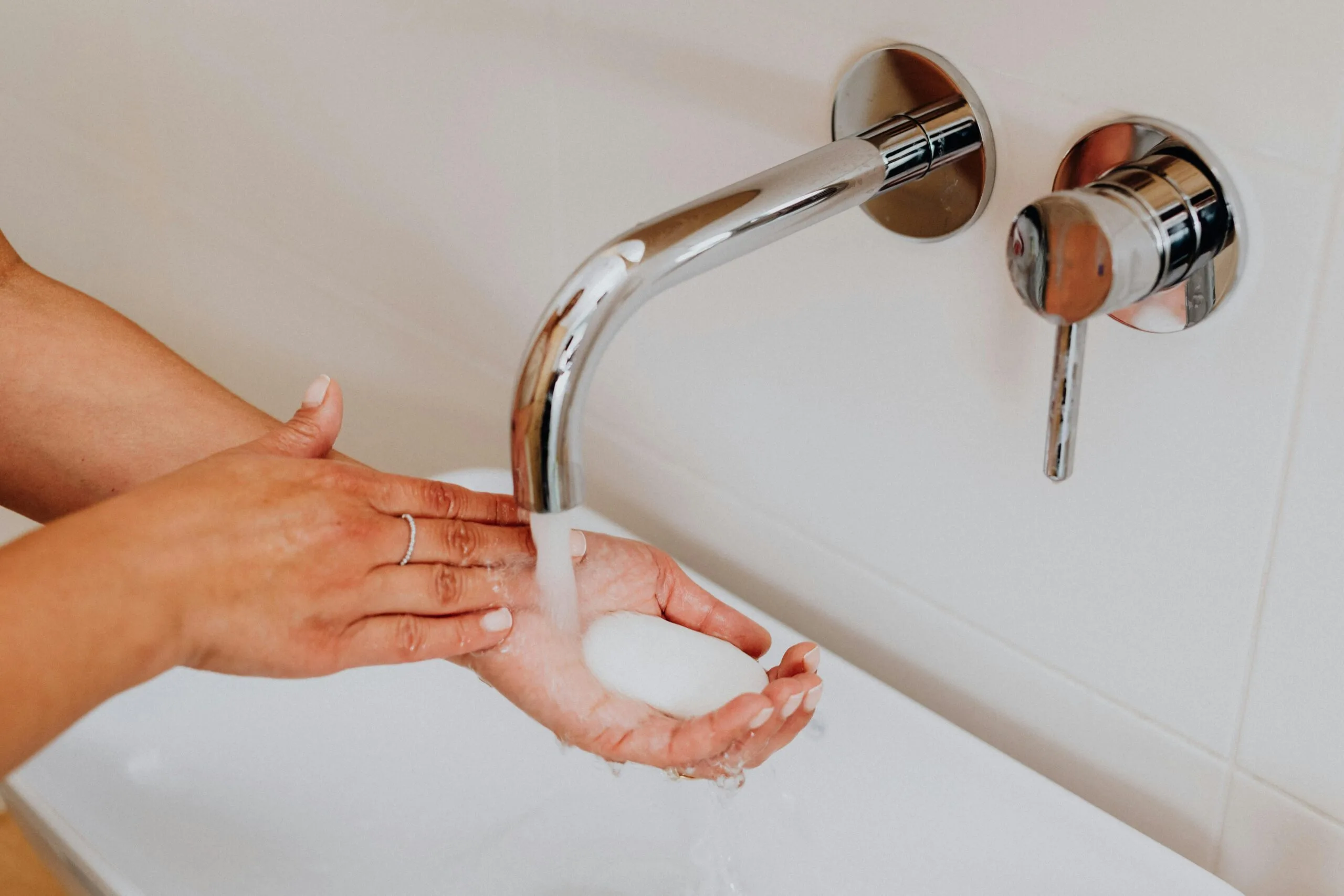 Clean hands with soap under running water promoting hygiene.