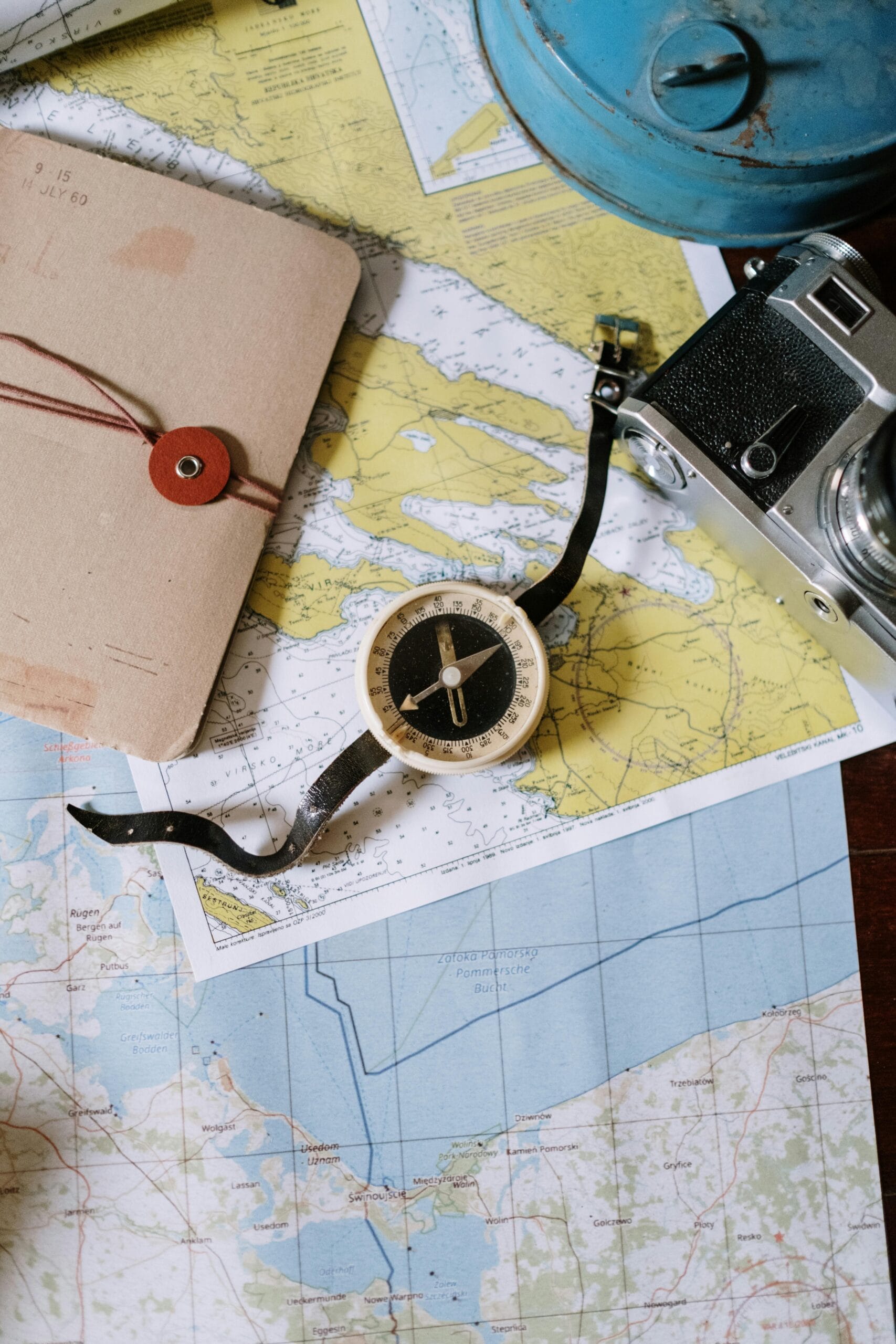 Planning your first African safari 1 Compass and camera on a vintage map flat lay, perfect for travel planning and navigation themes.
