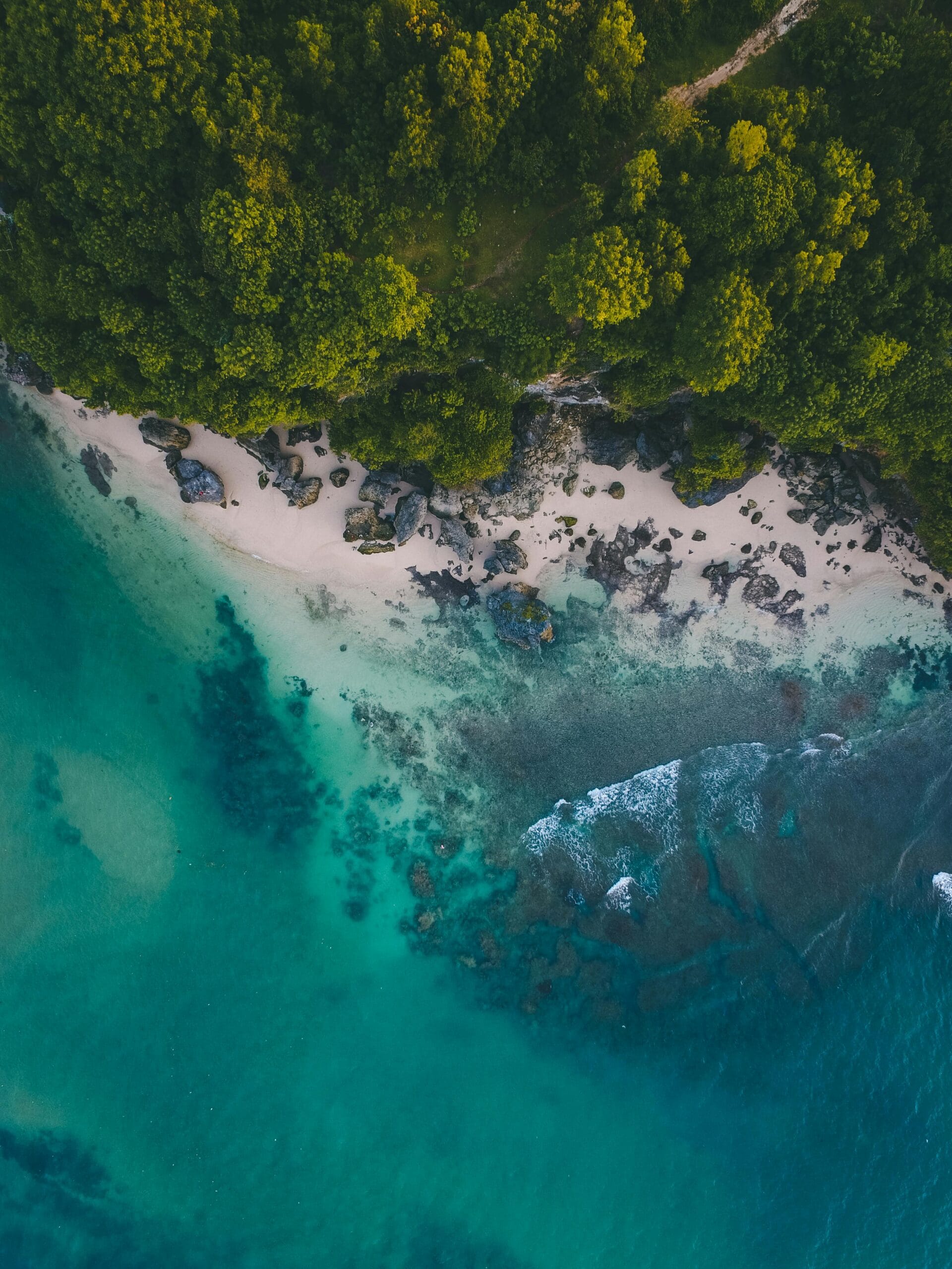 10-Day Mid-Range Safari: From Bush to Beach Escape 1 Stunning aerial view of a pristine beach in Bali with turquoise waters and lush greenery.