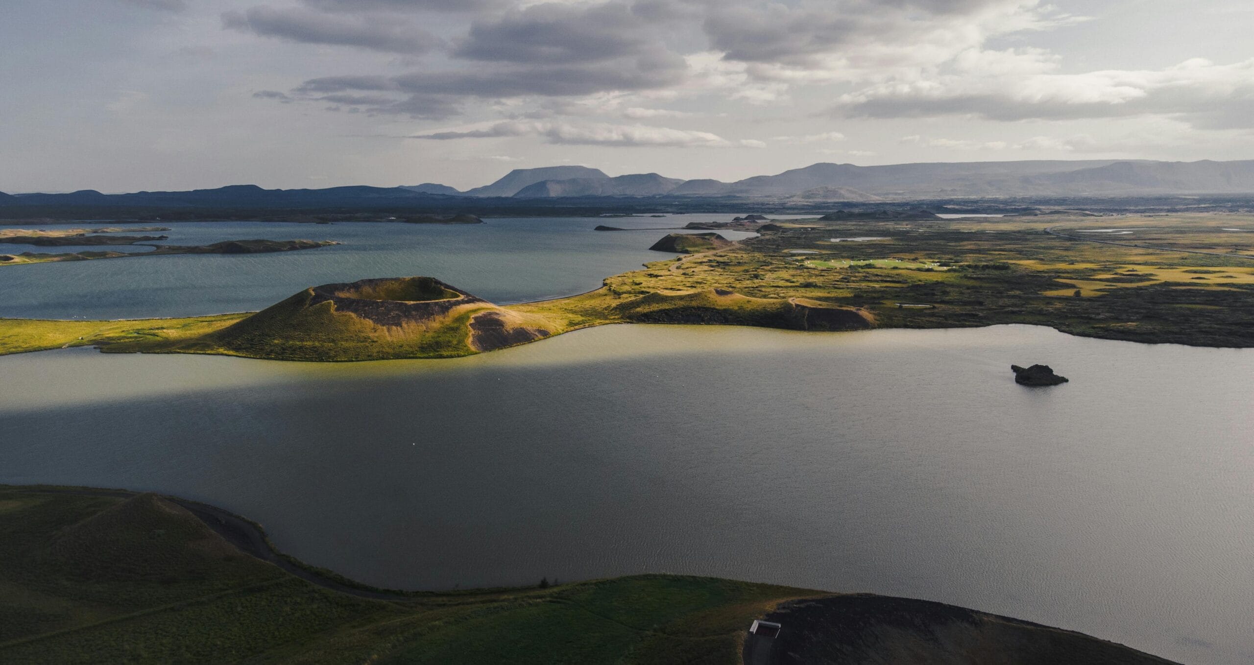 A breathtaking aerial view of Iceland's serene lakes and volcanic landscapes bathed in gentle light.