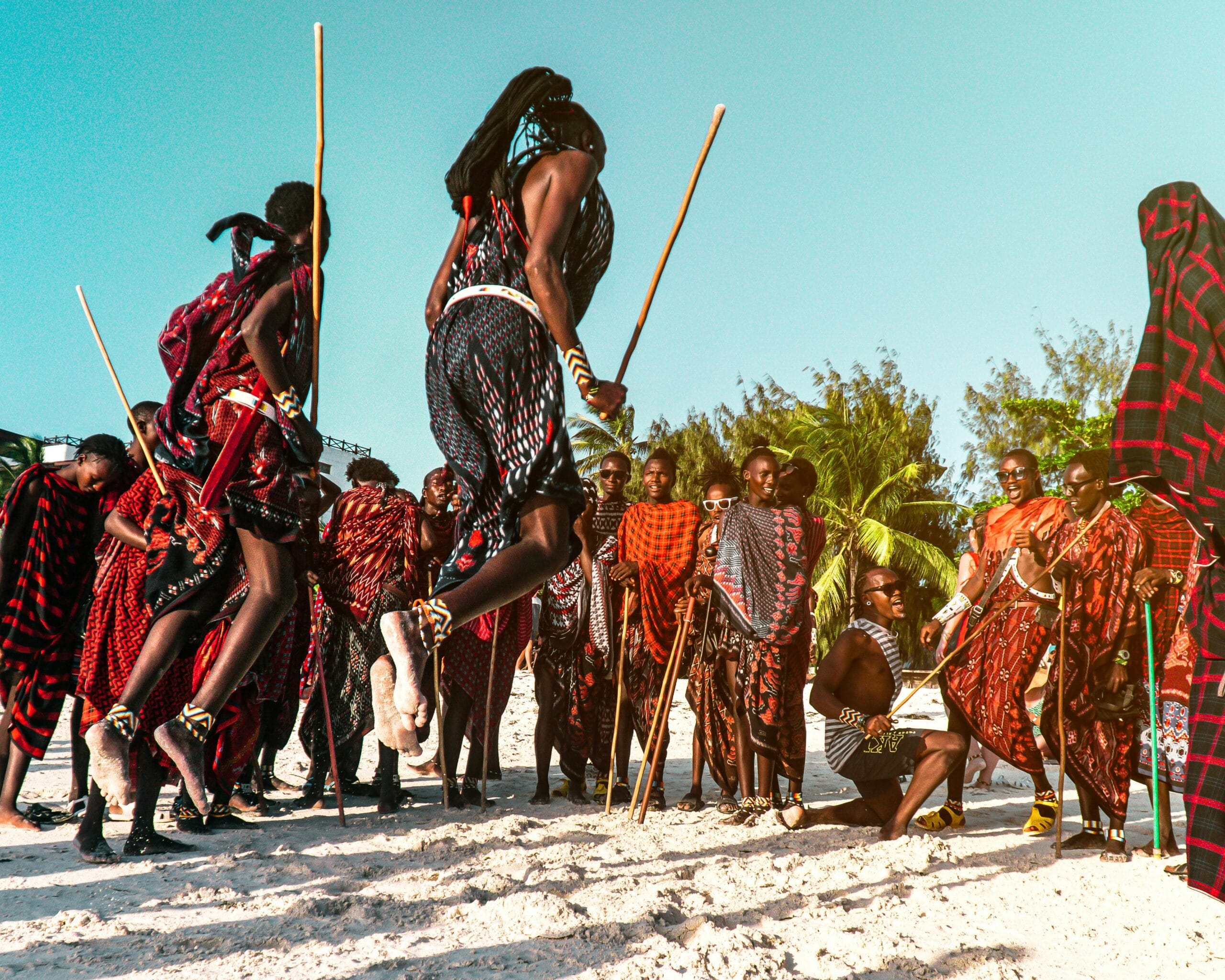 A captivating scene of Maasai warriors performing a traditional jumping dance on Nungwi Beach, Tanzania.